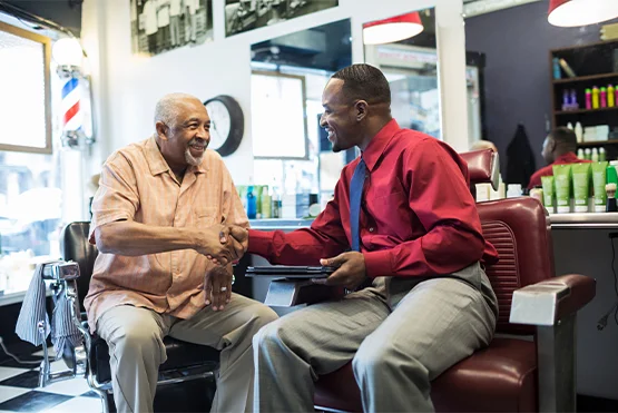 Two males talking in a barbershop